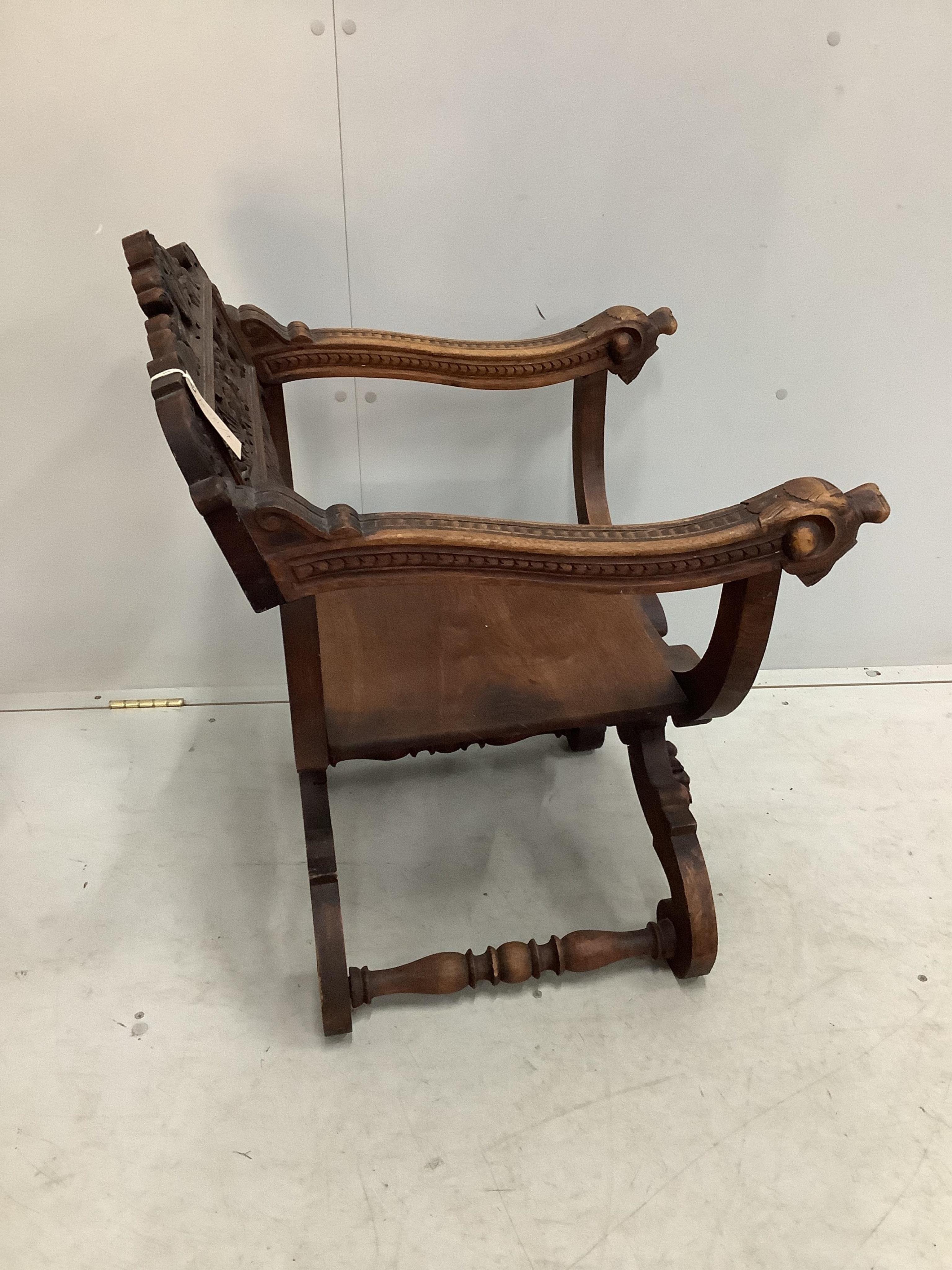 A carved 'X' framed chair, width 58cm, depth 53cm, height 79cm. Condition - fair